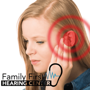 woman holding her ear with red circles emanating from it indicating pain