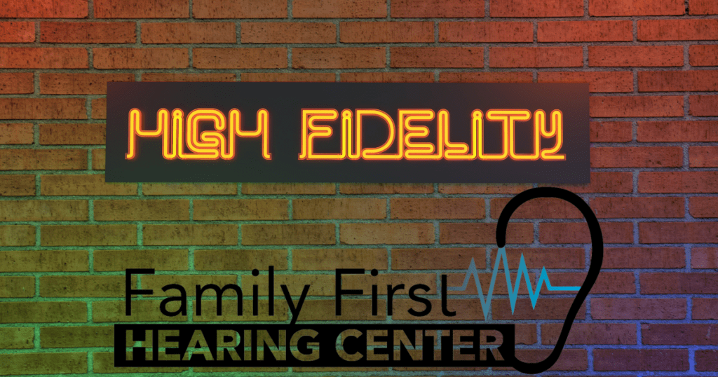 a brick wall with a neon sign that says high fidelity