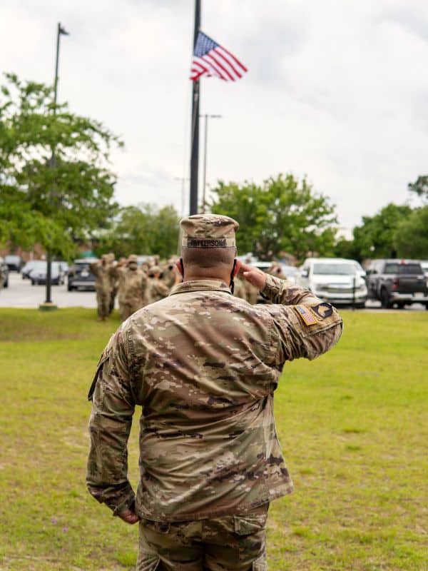 military member saluting the flag